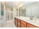 Bright bathroom featuring double vanity, shower and soaking tub with tile floors at 10732 Trolley Run Dr, Cornelius, NC 28031