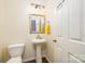 Powder room featuring a pedestal sink, mirror, and neutral color palette at 10732 Trolley Run Dr, Cornelius, NC 28031