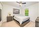 Comfortable bedroom with natural light, neutral carpet, ceiling fan and landscape art at 10732 Trolley Run Dr, Cornelius, NC 28031