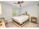 Guest bedroom with natural light, neutral carpet, ceiling fan and wooden nightstand at 10732 Trolley Run Dr, Cornelius, NC 28031