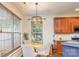 Cozy dining area featuring hardwood floors and a stylish pendant light fixture at 10732 Trolley Run Dr, Cornelius, NC 28031