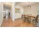 Open dining room boasts hardwood floors, stylish lighting, and seamless transitions to other living spaces at 10732 Trolley Run Dr, Cornelius, NC 28031