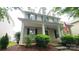 Charming home showcasing a covered front porch, complemented by well-maintained landscaping and an American flag at 10732 Trolley Run Dr, Cornelius, NC 28031