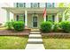 Charming home showcasing a covered front porch, complemented by well-maintained landscaping and an American flag at 10732 Trolley Run Dr, Cornelius, NC 28031