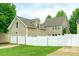 Two-story home featuring a two car garage and a large fenced-in backyard with lush green grass at 10732 Trolley Run Dr, Cornelius, NC 28031