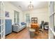 Inviting home office boasts hardwood floors, stylish decor, and ample natural light from large windows at 10732 Trolley Run Dr, Cornelius, NC 28031