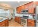 Kitchen showcasing cherry cabinets, granite countertops, and stainless steel appliances at 10732 Trolley Run Dr, Cornelius, NC 28031