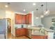 Bright kitchen with cherry cabinets, granite countertops and stainless steel dishwasher at 10732 Trolley Run Dr, Cornelius, NC 28031