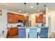 Open-concept kitchen with cherry cabinets, stainless steel appliances, and pendant lighting at 10732 Trolley Run Dr, Cornelius, NC 28031