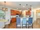 Open-concept kitchen featuring cherry cabinets, stainless steel appliances, and barstool seating at 10732 Trolley Run Dr, Cornelius, NC 28031