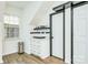 This kitchenette features white cabinets, modern finishes, and stainless steel appliances near extra storage at 10732 Trolley Run Dr, Cornelius, NC 28031