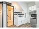 Bright kitchenette features a sink, mini fridge, modern finishes and is conveniently located next to the bathroom at 10732 Trolley Run Dr, Cornelius, NC 28031