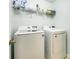 Efficient laundry room with modern washer, dryer, and overhead storage at 10732 Trolley Run Dr, Cornelius, NC 28031