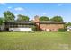 Well-maintained backyard showing a red brick home and screened in porch on a green lawn at 1155 Melrose Dr, Rock Hill, SC 29732