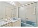 A well-lit bathroom with a combination shower and tub, classic vanity and neutral accents at 1155 Melrose Dr, Rock Hill, SC 29732