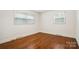 Bright bedroom with hardwood floors and two windows offering plenty of natural light at 1155 Melrose Dr, Rock Hill, SC 29732