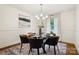 Elegant dining room featuring a modern chandelier, stylish round table, and large windows, perfect for entertaining guests at 1155 Melrose Dr, Rock Hill, SC 29732