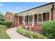 Inviting front porch featuring brick columns, manicured landscaping, and decorative lighting, enhancing the home's curb appeal at 1155 Melrose Dr, Rock Hill, SC 29732