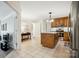 Open kitchen featuring tile flooring, center island with granite countertops and wooden cabinetry at 1155 Melrose Dr, Rock Hill, SC 29732