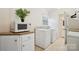 Functional laundry room featuring a washer, dryer, storage cabinets, and neutral walls at 1155 Melrose Dr, Rock Hill, SC 29732