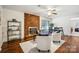 Inviting living room featuring a brick fireplace, wood paneling, and stylish decor, creating a cozy and sophisticated ambiance at 1155 Melrose Dr, Rock Hill, SC 29732