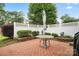 An outdoor patio with brick pavers, white fence, and garden featuring an umbrella covered table at 1155 Melrose Dr, Rock Hill, SC 29732