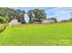 Expansive green backyard with a wooden fence surrounding the property, and the main house with a large deck at 117 Autumn Woods Dr, Kings Mountain, NC 28086