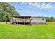 The backyard features a covered deck and a well-manicured lawn, perfect for outdoor enjoyment at 117 Autumn Woods Dr, Kings Mountain, NC 28086