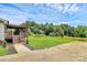 A lush, green backyard featuring a wooden deck and a well-maintained lawn under a sunny sky at 117 Autumn Woods Dr, Kings Mountain, NC 28086