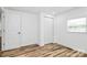 Bright bedroom featuring wood-look floors, window with blinds and closet with sliding doors at 117 Autumn Woods Dr, Kings Mountain, NC 28086