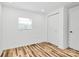 Bedroom featuring wood-look floors, window with blinds and closet with sliding doors at 117 Autumn Woods Dr, Kings Mountain, NC 28086