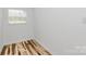Bright bedroom featuring wood-look floors and a window with white blinds for natural light at 117 Autumn Woods Dr, Kings Mountain, NC 28086