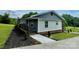Charming home with a covered porch, stylish siding, and landscaped garden at 117 Autumn Woods Dr, Kings Mountain, NC 28086