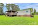 Home exterior featuring a large covered deck and well-maintained landscaping at 117 Autumn Woods Dr, Kings Mountain, NC 28086