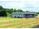 Quaint blue home featuring a new wooden fence, front porch, and well-maintained lawn at 117 Autumn Woods Dr, Kings Mountain, NC 28086