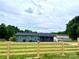 Charming blue home with a lovely wood fence, lush green yard, and inviting front porch at 117 Autumn Woods Dr, Kings Mountain, NC 28086