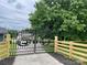 Iron gate with deer silhouettes, surrounded by a wooden fence and green lawn at 117 Autumn Woods Dr, Kings Mountain, NC 28086