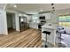 Modern kitchen featuring stainless steel appliances, white cabinets, and a breakfast bar, open to living space at 117 Autumn Woods Dr, Kings Mountain, NC 28086
