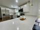 Bright, modern kitchen with white quartz countertops, stainless steel appliances, and elegant pendant lighting at 117 Autumn Woods Dr, Kings Mountain, NC 28086
