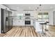 Modern updated kitchen with stainless appliances, white cabinets, and a center island with barstool seating at 117 Autumn Woods Dr, Kings Mountain, NC 28086