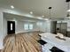 Open-concept living space with natural light, wood floors, and a kitchen featuring a breakfast bar at 117 Autumn Woods Dr, Kings Mountain, NC 28086