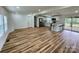 Open-concept living area featuring wood floors, white walls, and a modern kitchen with stainless steel appliances at 117 Autumn Woods Dr, Kings Mountain, NC 28086