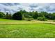Extensive wooden fencing surrounds a large grass field in a country landscape at 117 Autumn Woods Dr, Kings Mountain, NC 28086
