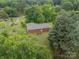 Aerial view of a brick home with a large, wooded lot, showcasing its serene and private setting at 1188 Rainbow Cir, Catawba, SC 29704