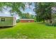 Spacious, green backyard with a storage shed, surrounded by mature trees providing shade and privacy at 1188 Rainbow Cir, Catawba, SC 29704