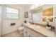 Bright bathroom with a large mirror, neutral tiling, and a window for natural light at 1188 Rainbow Cir, Catawba, SC 29704