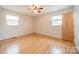 Empty bedroom showcasing hardwood floors and natural light from the windows at 1188 Rainbow Cir, Catawba, SC 29704