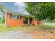 Charming brick home with black shutters and a cozy front porch, nestled under a beautiful, mature tree at 1188 Rainbow Cir, Catawba, SC 29704