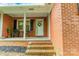 Charming brick home featuring a cozy front porch with seating and a welcoming entrance at 1188 Rainbow Cir, Catawba, SC 29704