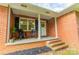 Charming brick home featuring a cozy front porch with seating and a welcoming entrance at 1188 Rainbow Cir, Catawba, SC 29704